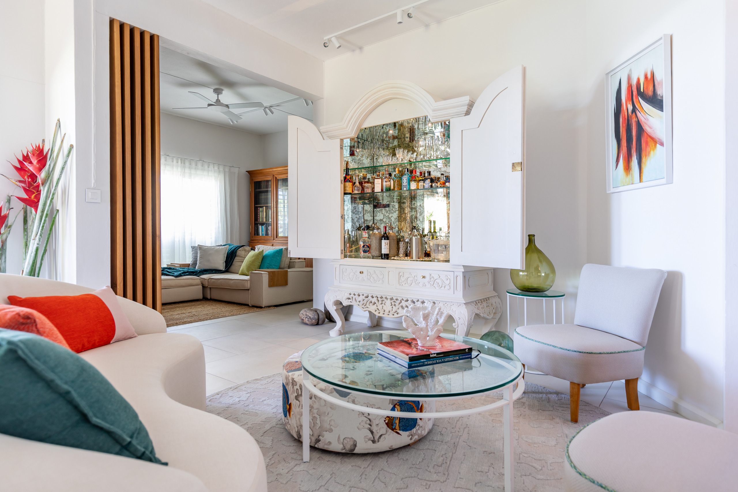 Elegant living room featuring modern furniture, a marble coffee table, and large windows with a view of the garden.